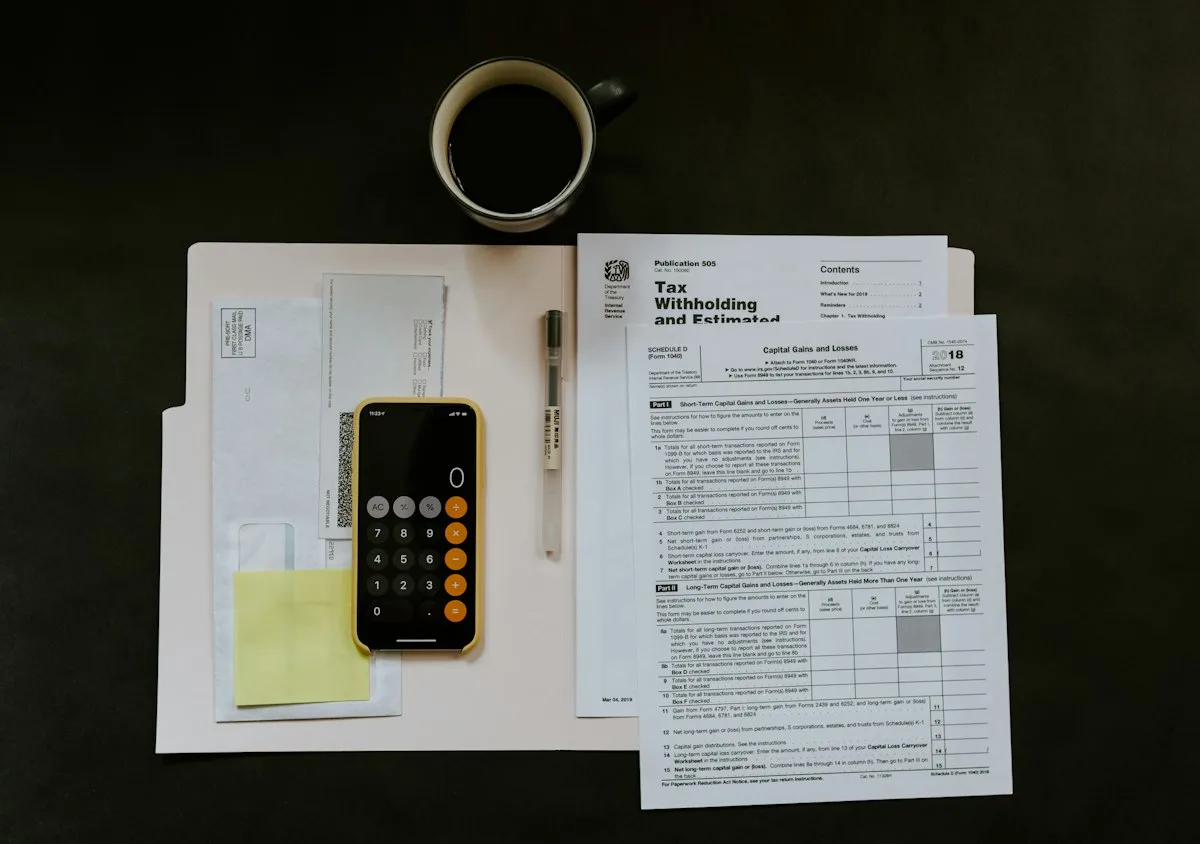 Person using electronic desktop calculator analyzing monthly income percentage categories