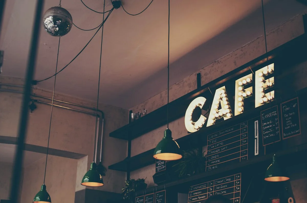 Warm ceramic coffee cup and plate on cafe table representing discretionary lifestyle wants