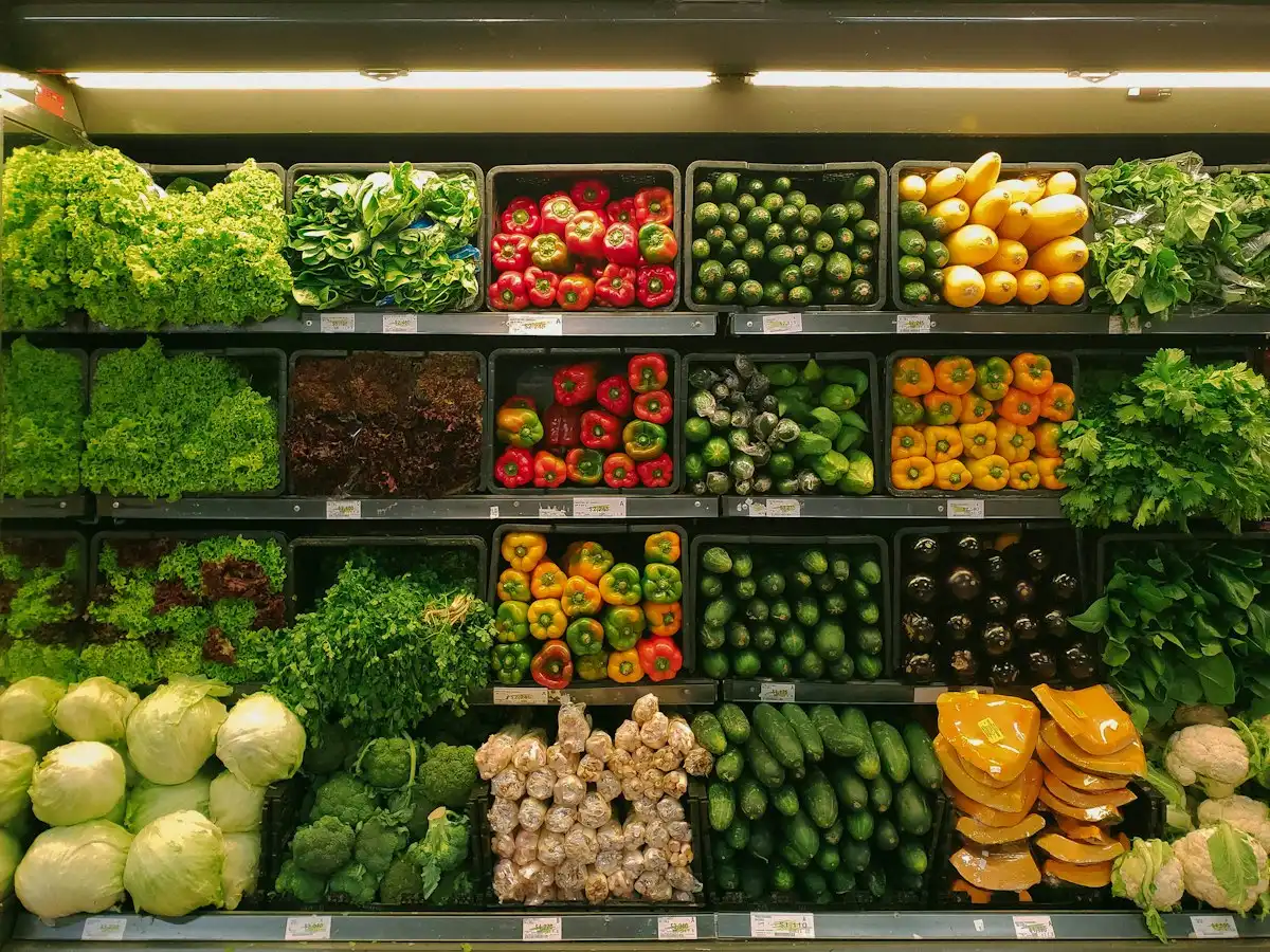 Shopping cart in supermarket filled with fresh nutritious food representing essential needs