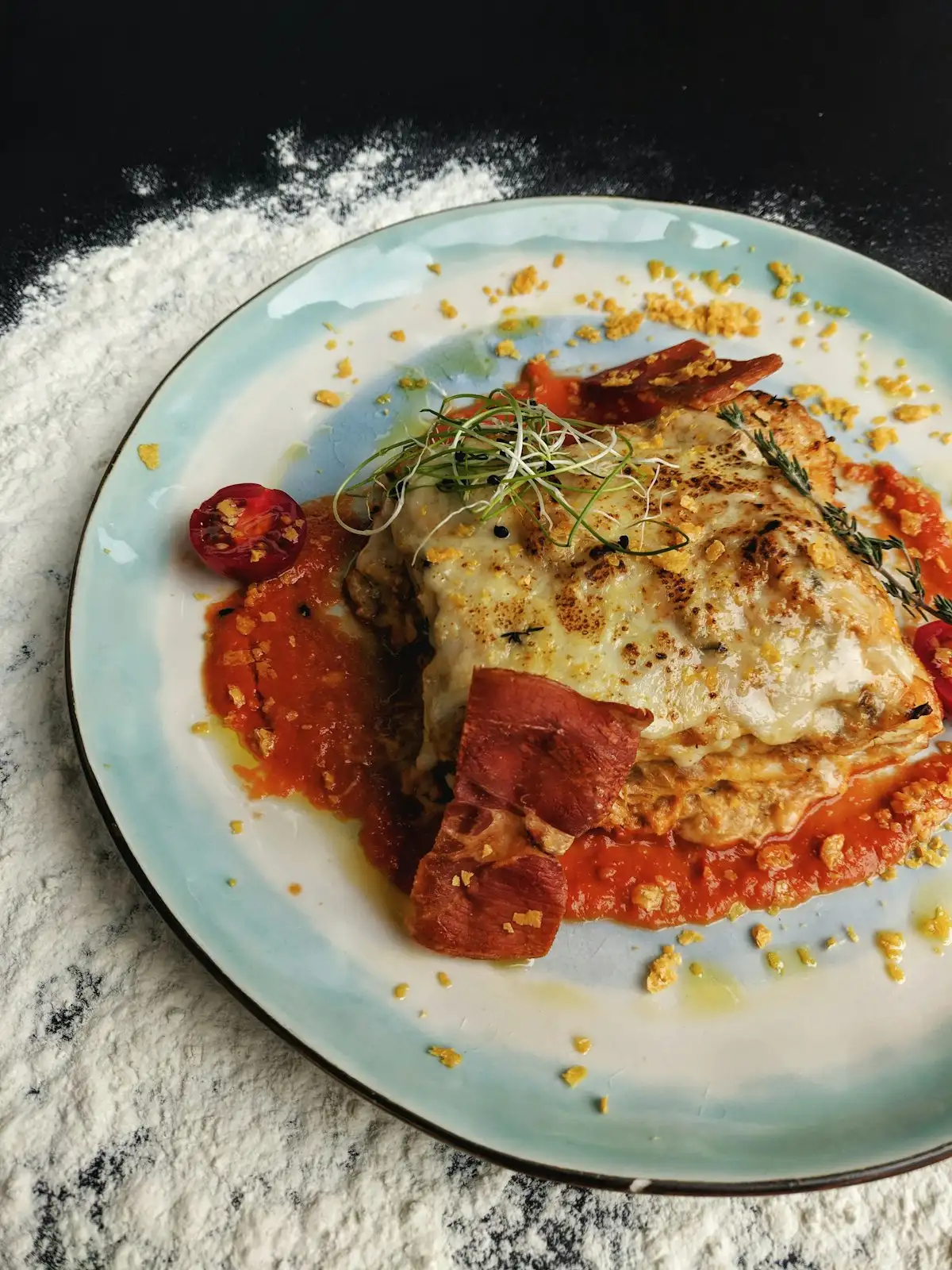 Freshly baked homemade vegetable lasagna in glass casserole dish with golden bubbling cheese