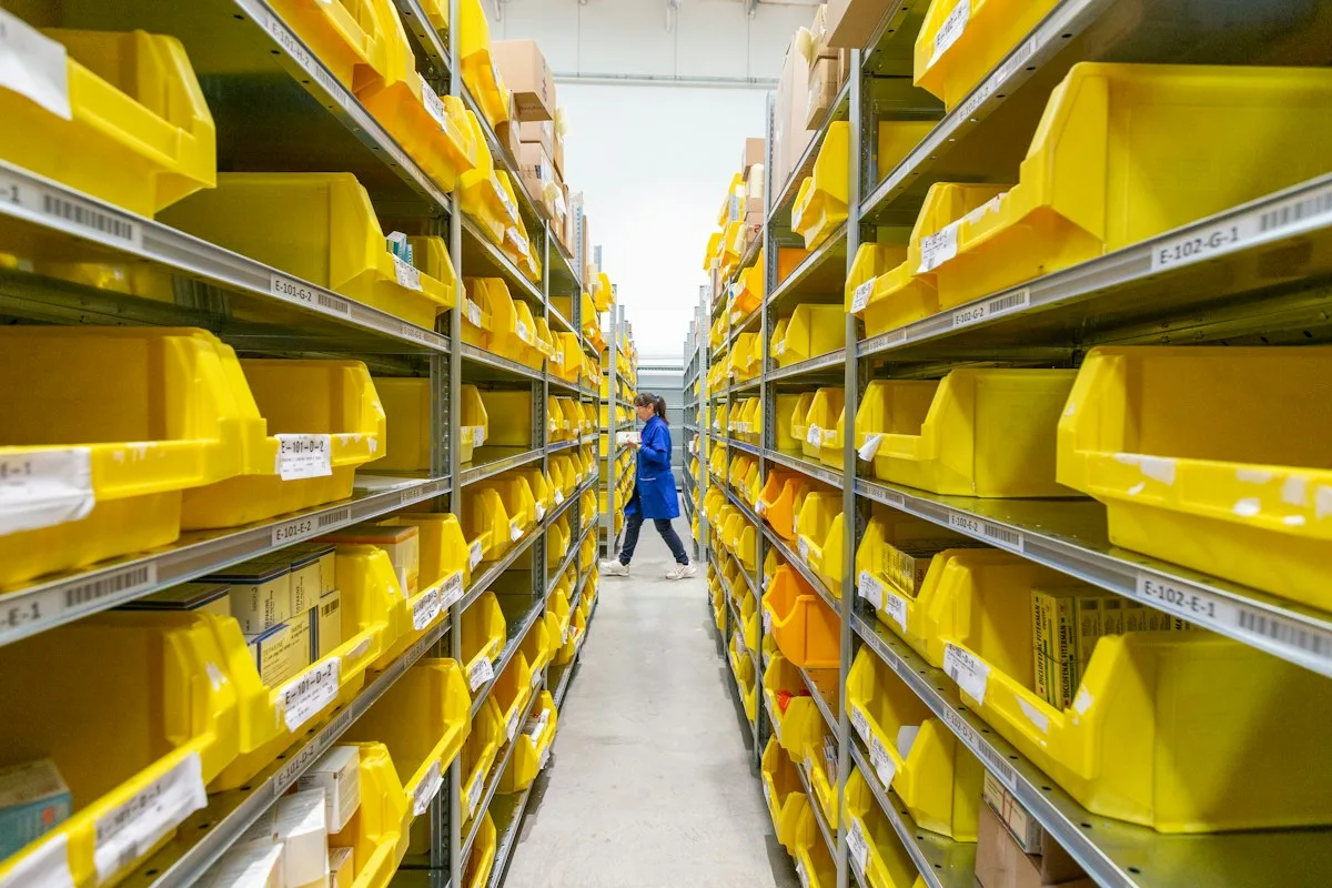 Massive modern e-commerce warehouse shelves filled with organized brown shipping boxes