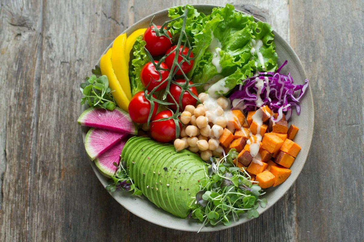 Wholesome colorful chopped vegetables and fresh greens ready for simmering in slow cooker pot
